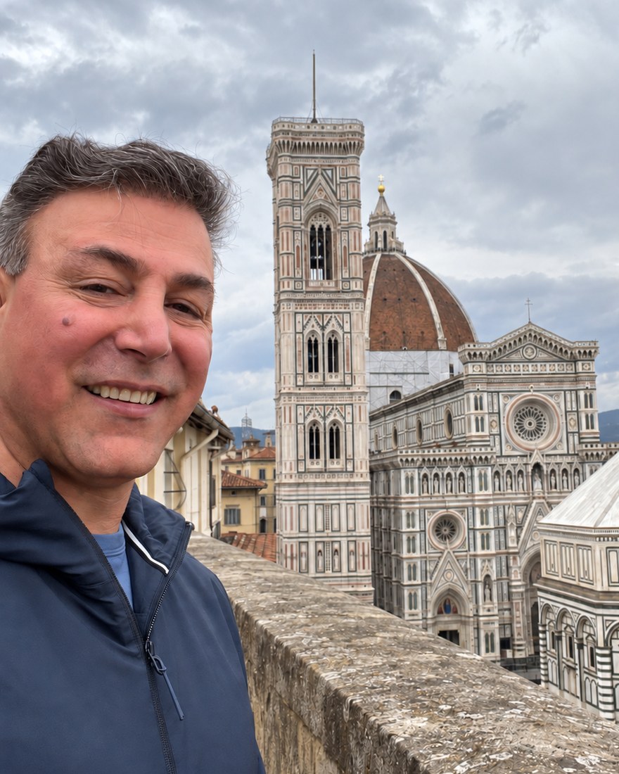 Daniel Hashemi, smiling, with the cathedral of Florence behind him